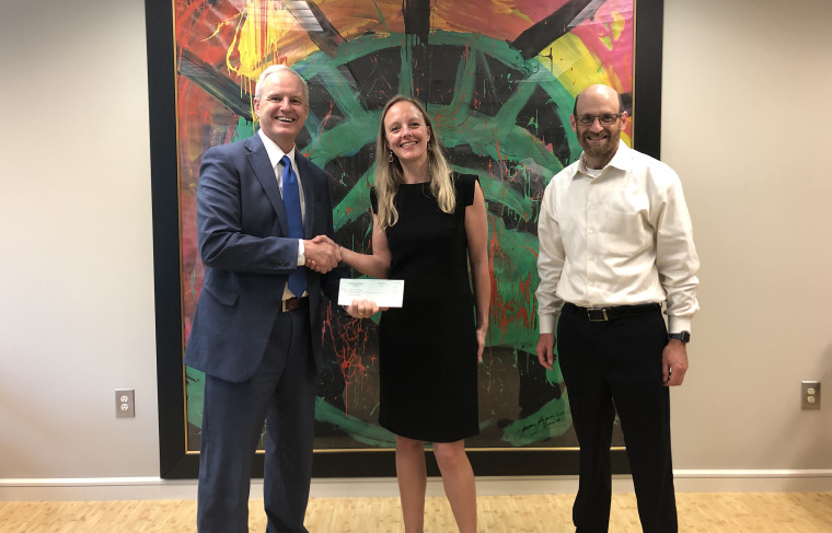 Charles Kuck, Willemijn Keizer (SPLC's Director of Institutional Giving), Daniel Werner (Director of SIFI) hold a check from 21 Savage