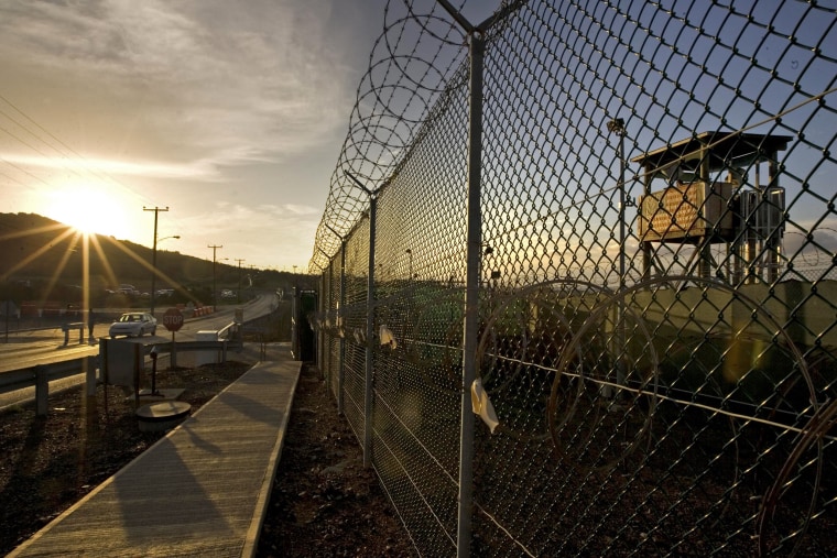 Image: The sun rises over Camp Delta detention compound at Guantanamo Bay