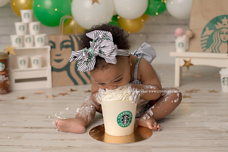 Aria Dillon digs into a Starbucks cup smash cake for an adorable photoshoot.