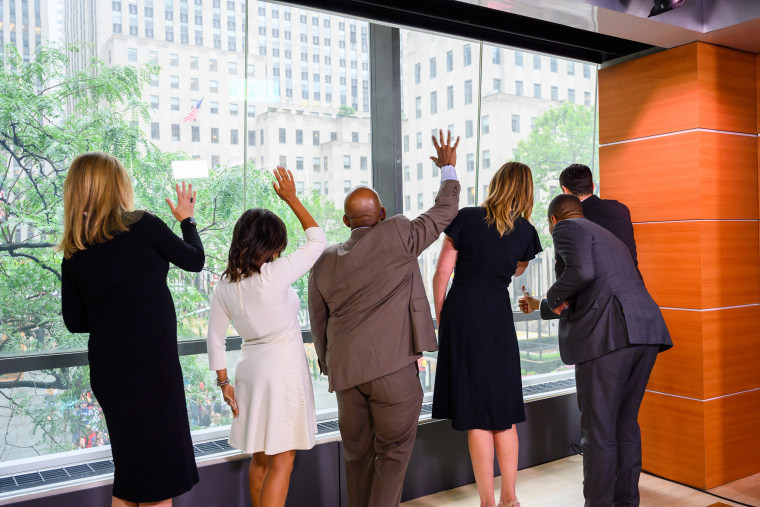 The TODAY anchors give a wave to the crowd through the famous window on the world in Studio 1A. 