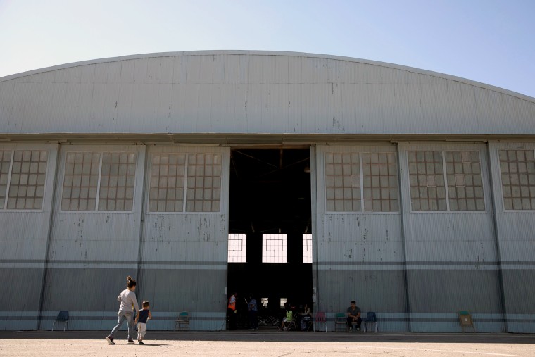Image: A WWII hangar is being used as a shelter and processing center for migrants being released by U.S. Border Patrol in Deming