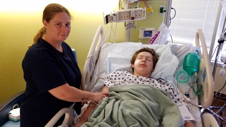 Image: Eli Gregg recovers at the hospital in Kansas City with his mother, Jimmy Russell.