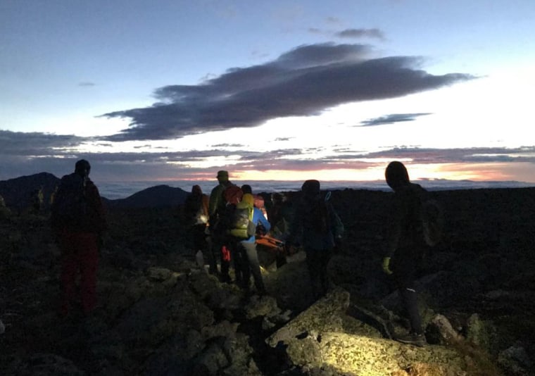 Rescuers carry James Clark of Dublin, Ohio, to Mount Washington Auto Road in New Hampshire