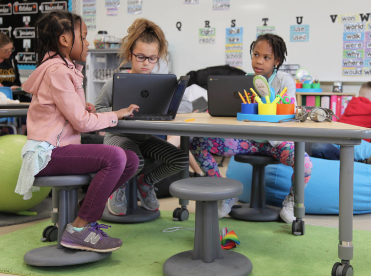 Wobble stools allow second graders, from left, Zariah Atwater, Juliette Ortiz and Kamilla Armstrong to rock and spin in between solving math problems at Thomas Hooker Elementary School.