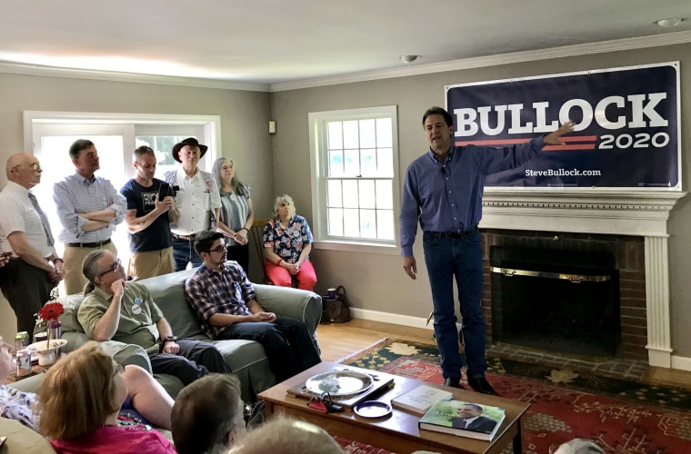 Image: 2020 Democratic presidential candidate and Montana Gov. Steve Bulllock talks to voters at a house party in Nashua, New Hampshire, on June 22, 2019.