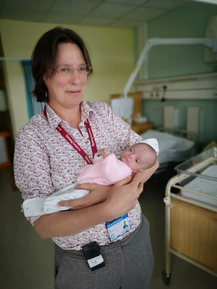 Professor Siobhan Quenby holding baby Ivy.