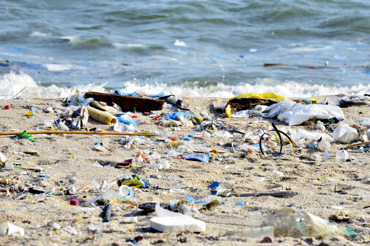 Beach pollution. Plastic bottles and other trash on sea beach