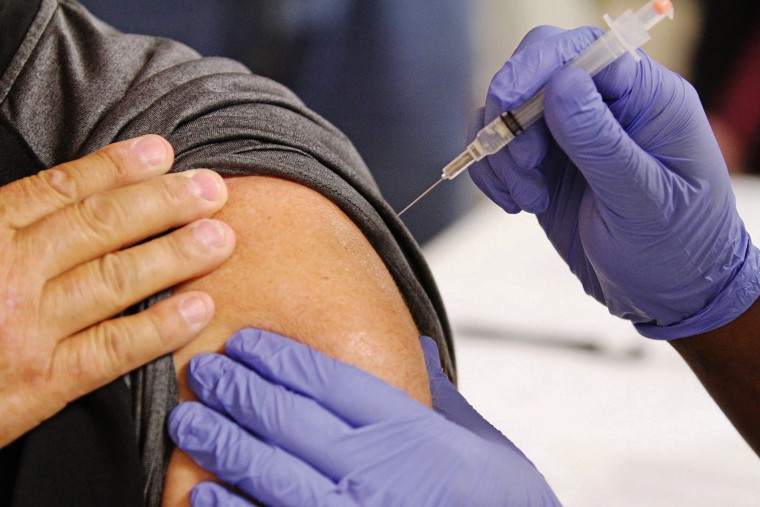 A South Arkansas Community College practical nursing student delivers a flu shot during the Arkansas Department of Health's mass flu clinic in 2013.