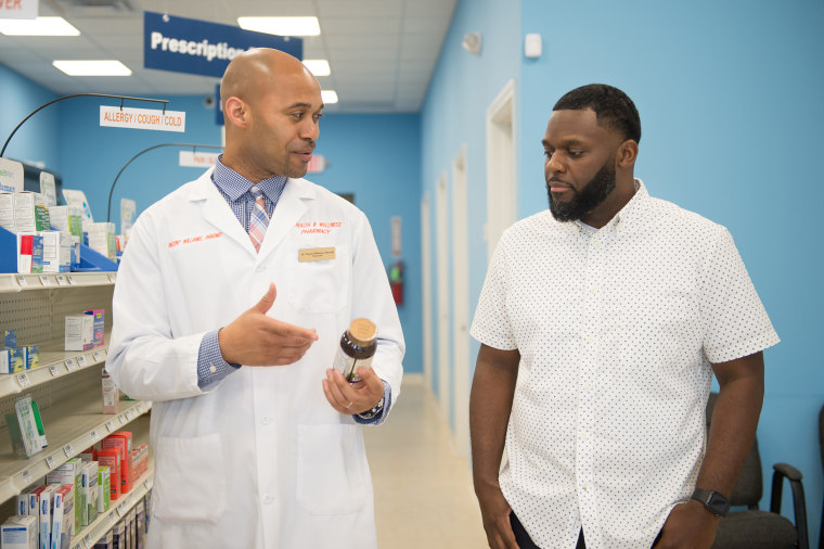 Vincent Williams and Bernard Macon discuss medication at LV Health and Wellness Pharmacy in Shiloh, Illinois on June 6, 2019.