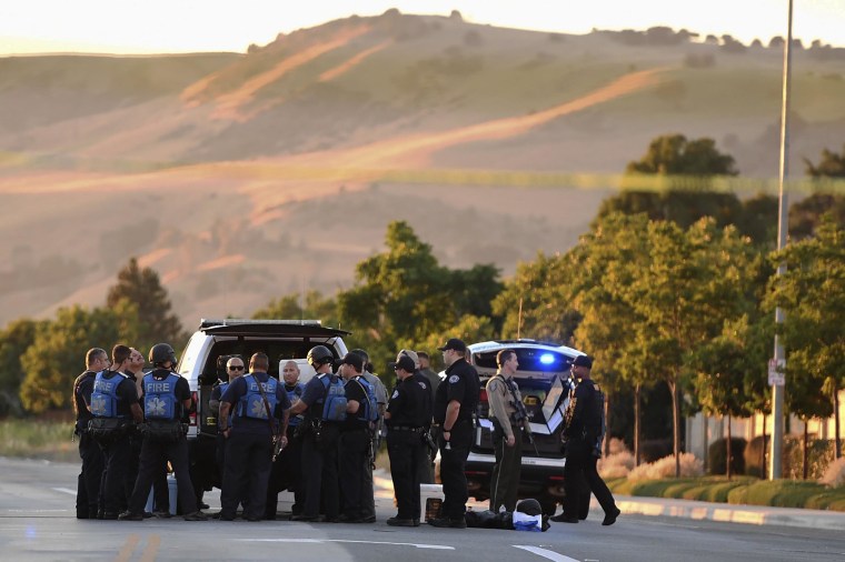 Image: Police investigate at the scene of a shooting at the Morgan Hill Ford Store in Morgan Hill, Calif.