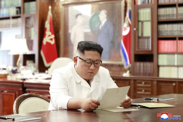 Image: North Korean leader Kim Jong Un reads a letter from U.S. President Donald Trump, in Pyongyang