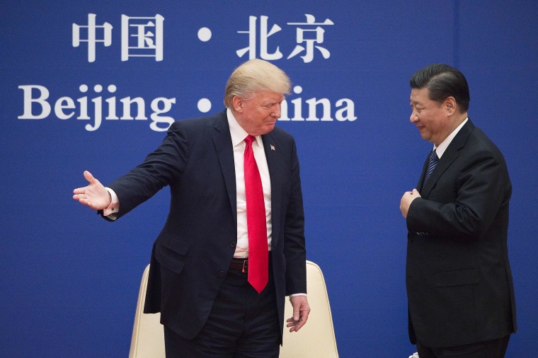 Image: President Donald Trump greets China's President Xi Jinping during a business leaders event at the Great Hall of the People in Beijing