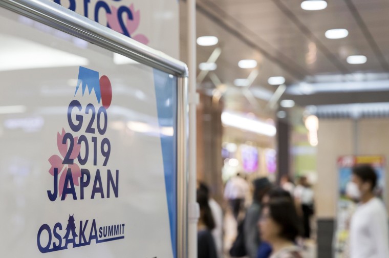 Image: A sign for the G-20 Summit at a train station on June 26, 2019 in Osaka, Japan.