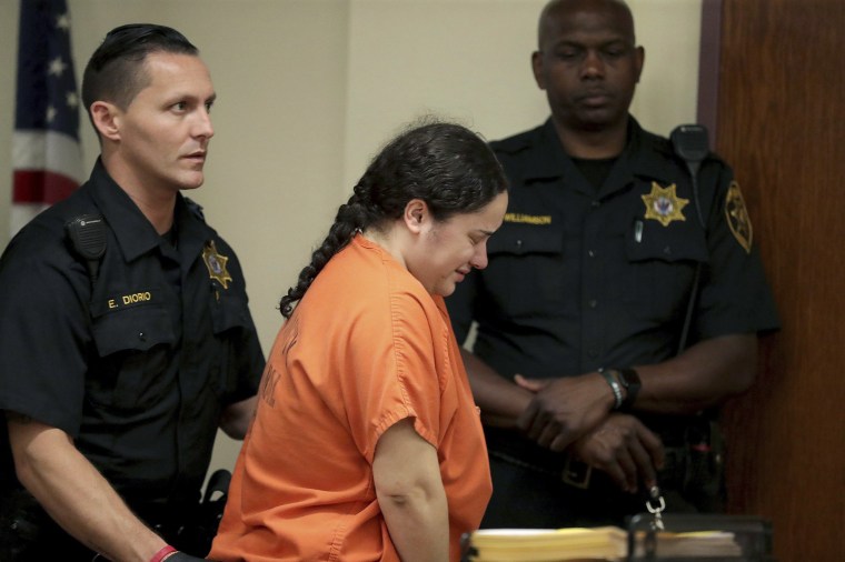 Image: Amanda Ramirez is escorted out of the courtroom after a pretrial detention hearing