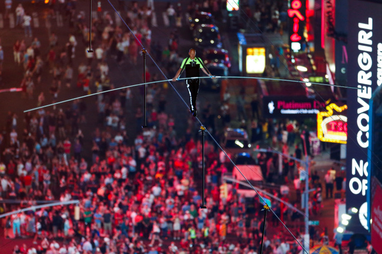 Image: Aerialist Wallenda walks the highwire with his sister Lijana over Times Square in New York