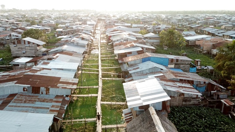 Image: Elevated walkways built by locals during the rainy season when floodwaters make the streets impassable.