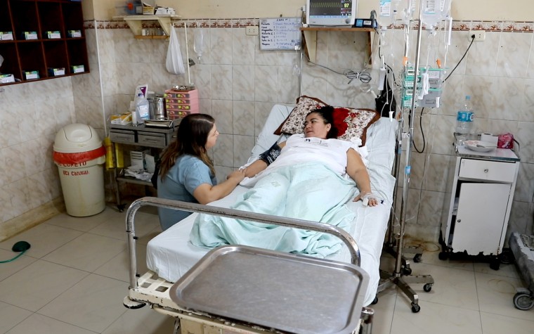 Image: UCLA student A.J. Green with a patient who suffered internal bleeding after gallbladder surgery.