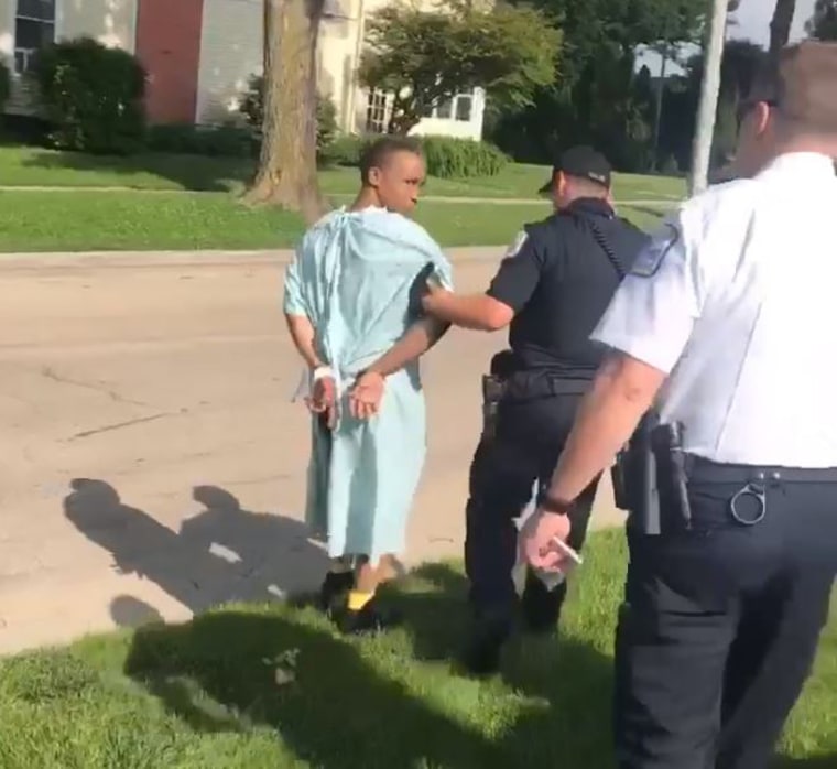 Shaquille Dukes is arrested by police in his hospital gown.
