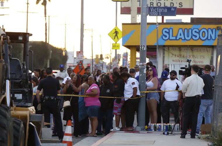 Image: People gather across the street of the Marathon Clothing store of rapper Nipsey Hussle in Los Angeles