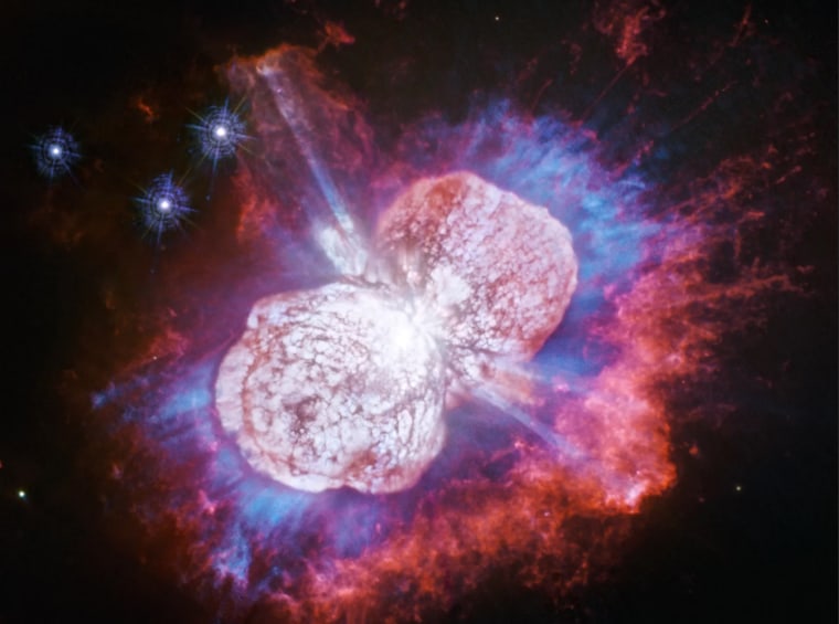 Eta Carinae, a distant star spouting twin nebulae of red, white and blue gas, is pumped for Independence Day.