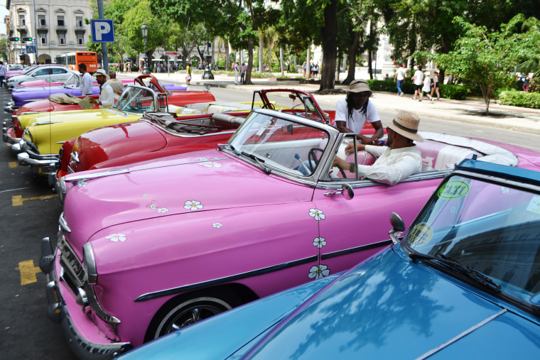 Alejandro Martin Ramos sits in his pink 1953 Chevrolet Bel Air in front of Havana's Central Park waiting for tourists on June 23, 2019.