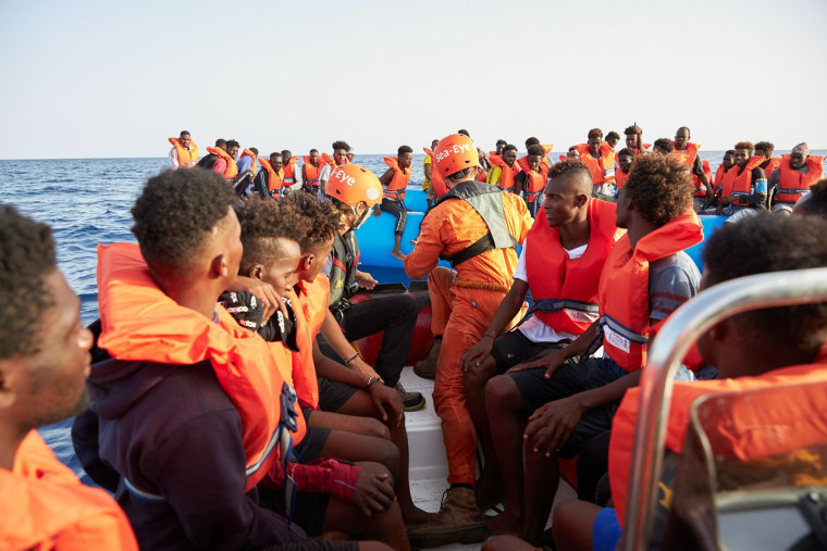 Image: The German migrant rescue charity NGO Sea-Eye helps people to get off an overloaded rubber boat spotted in international waters off the Libyan coast