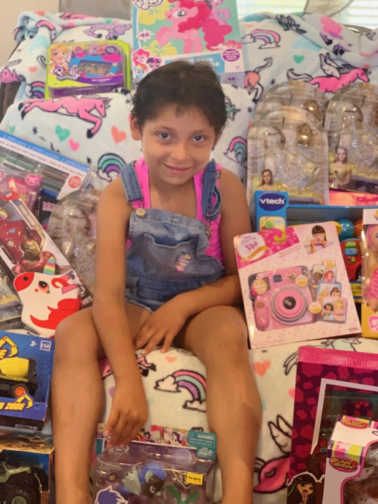 Zoe Figueroa with the presents she will donate.