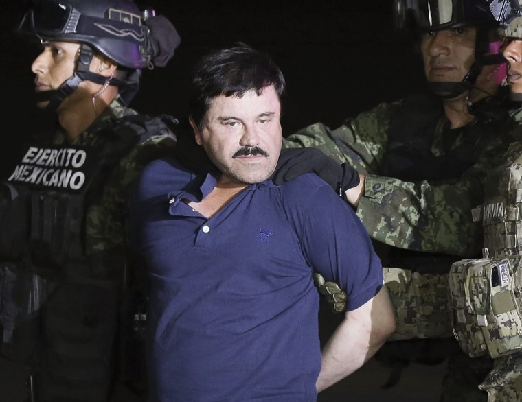 Joaquin "El Chapo" Guzman is escorted by authorities after his detention in Mexico City