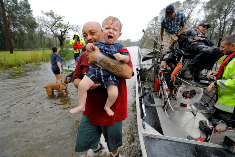Image: Oliver Kelly, 1 year old, cries as he is carried off the sheriff's airboat during his rescue from rising flood waters in the aftermath of Hurricane Florence in Leland, North Carolina