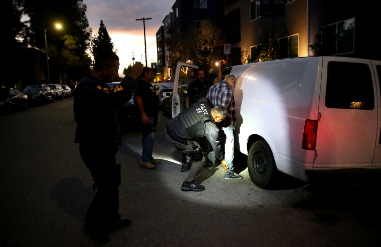 Image: A man is detained by Immigration and Customs Enforcement agents in Los Angeles on Oct. 14, 2015.