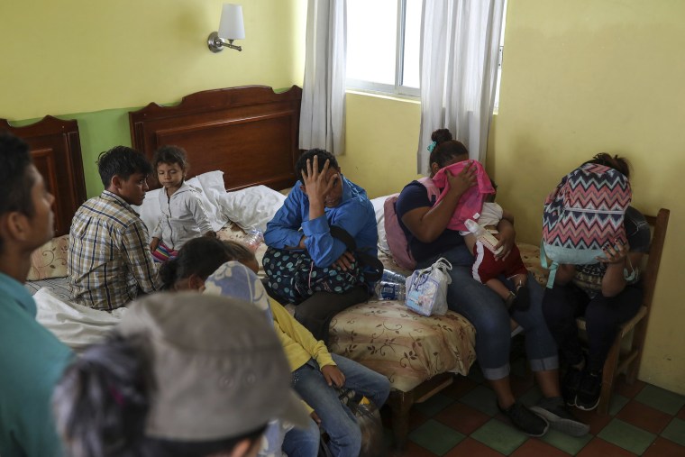 Image: Central American migrants sit together inside a room at the Latino hotel during a raid by Mexican immigration agents in Veracruz, Mexico
