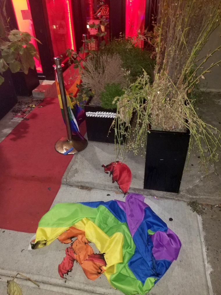 Image: A burned rainbow flag lays outside of Alibi Lounge in New York on July 8, 2019. The owner of the lounge says this is the second time in a month a pride flag has been burned at the entrance of the club, and the incident is being investigated as a ha