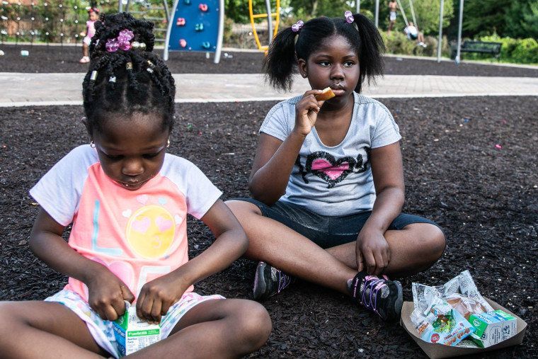 Nhyira Appiah, right, eats her meal at Rowley Park in East Orange.