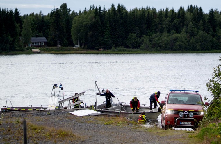 Image: An emergency services boat carries wreckage after a small airplane crashed in Umea, Sweden, on July 14, 2019.