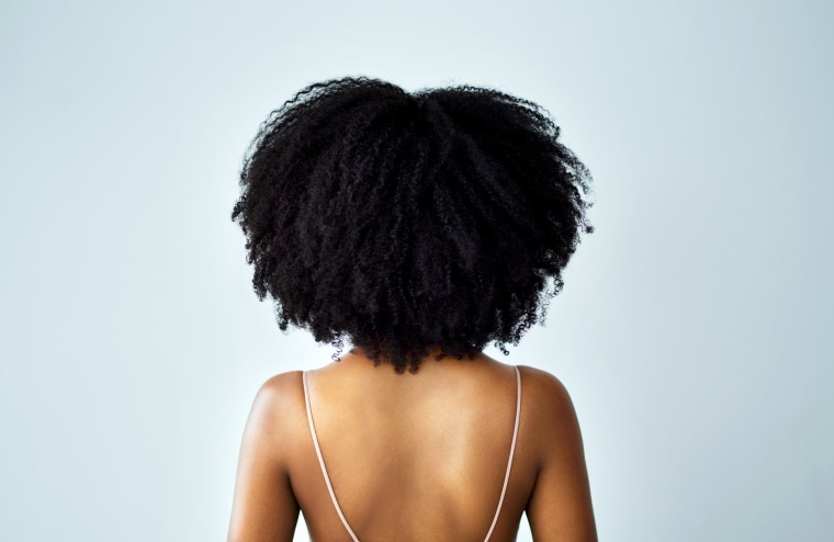 Image: Rearview studio shot of a young woman with curly hair