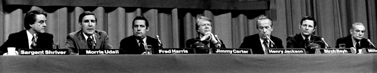 Image: Democrats Sargent Shriver, Morris Udall, Fred Harris, Jimmy Carter, Henry Jackson, BIrch Bayh and Milton Shapp at a forum in Boston on the eve of the New Hampshire primary on Feb. 24, 1976.