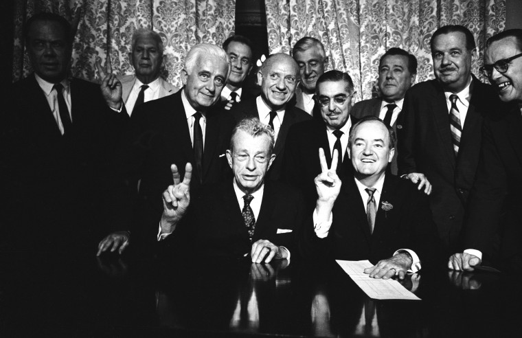 Image: Sen. Everett Dirksen, bottom left, and Sen. Hubert Humphrey, bottom right, pose with fellow senators after passing a vote for cloture on the Civil Rights Act in 1964.