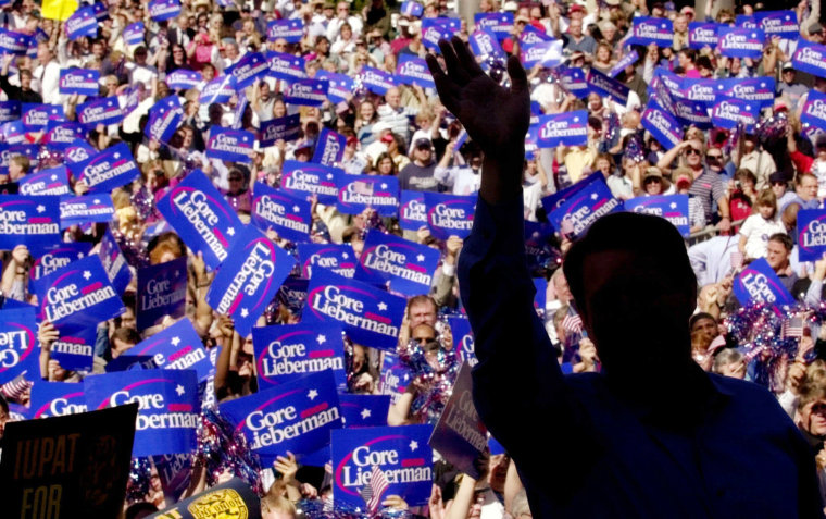 Image: Al Gore waves to supporters as he takes the stage at a campaign rally in Des Moines, Iowa, on Sept. 27, 2000.