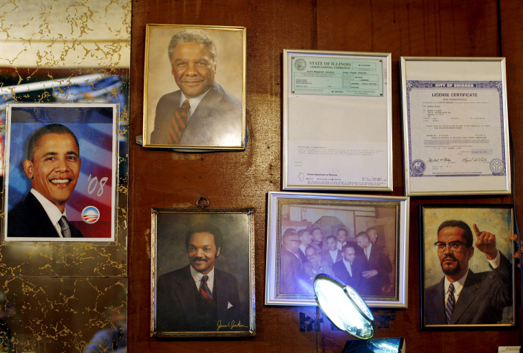 Image: A photo of Barack Obama hangs next to photos of other prominent black leaders in history, Malcom X, Rev. Jesse Jackson and Chicago Mayor Harold Washington, in Murph's Lounge in Chicago on Nov. 4, 2008.