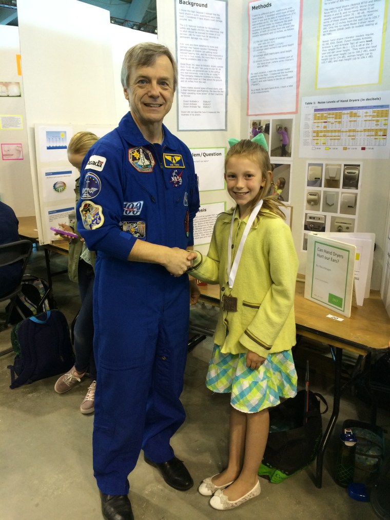 As part of the Calgary Youth Science Fair where Nora Keegan presented her research on how loud hand dryers are, she had the chance to meet Canadian astronaut Robert Thirsk. 
