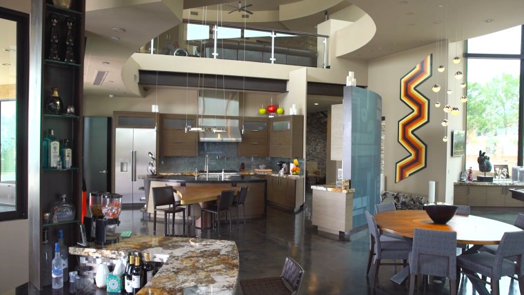 Lee's multi-use space features a full kitchen, dining area with lazy Susan, and an indoor/outdoor bar.