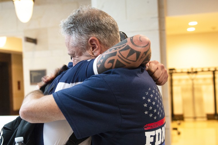 John Feal, 9/11 first responder, left, and Jon Stewart, former host of The Daily Show, hug after the Senate passed a bill for the permanent authorization of September 11th Victim Compensation Fund on Capitol Hill in Washington on Tuesday July 23, 2019.