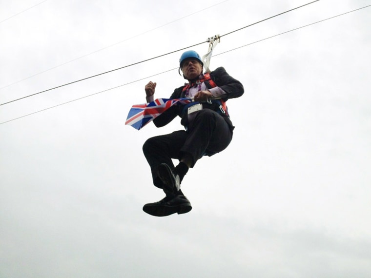 Image: London Mayor Boris Johnson dangles from a zipwire.