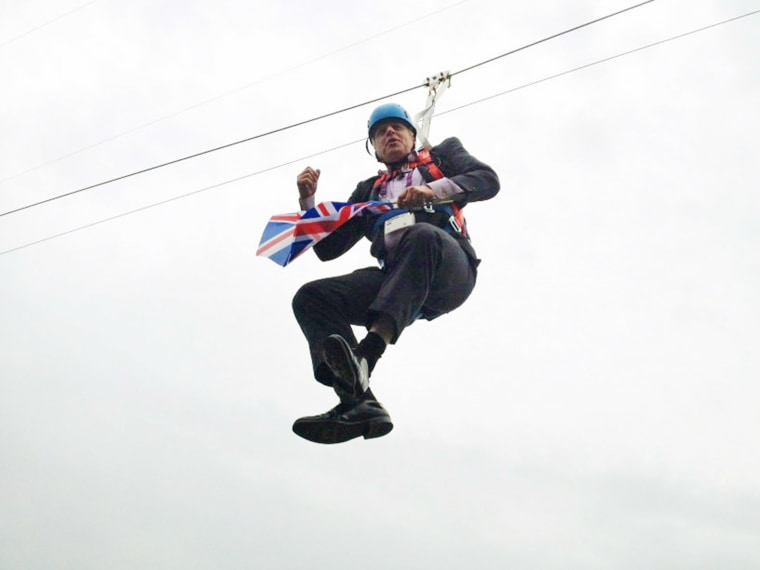 Image: London Mayor Boris Johnson dangles from a zipwire.