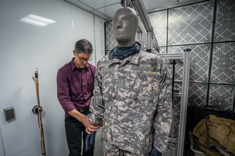 Researcher Julio Gonzalez prepares a sweating mannequin for a heat test at the U.S. Army Research Institute of Environmental Medicine.