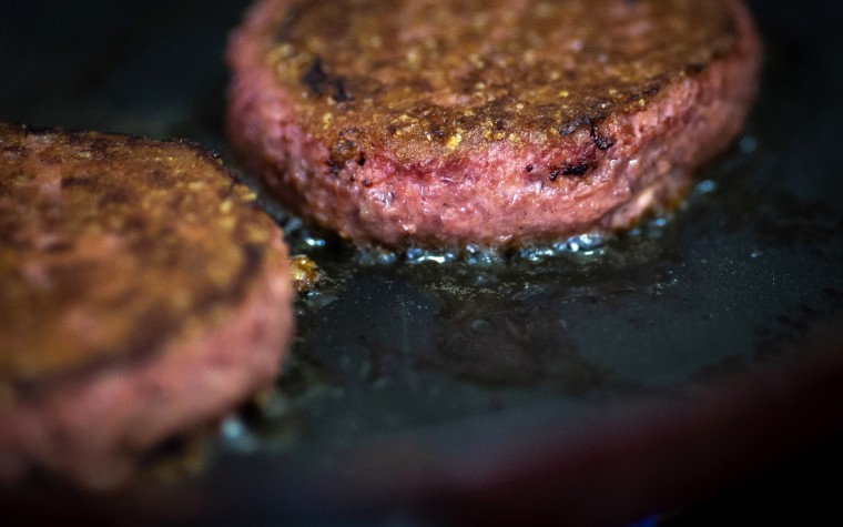 Image: Two Beyond Meat patties cook on a skillet in Brooklyn on June 13, 2019. Beyond Meat is a producer of plant-based meat substitutes.