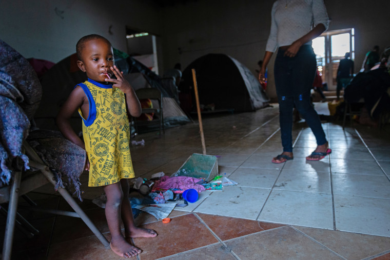 Pierre watches as her 2-year-old son, Adrian, plays. "When you have kids, you have to look for a better future for them," she says. Pierre shares one of the tents in the background with her husband and two children. Sleeping on a hard floor with a few blankets is uncomfortable for her. "When you're an immigrant and you're not working, it makes it hard to buy things that you need," she says. She expects to wait at the shelter for at least two more months before she can appear before a U.S. immigration judge. "Our number is 2,716."