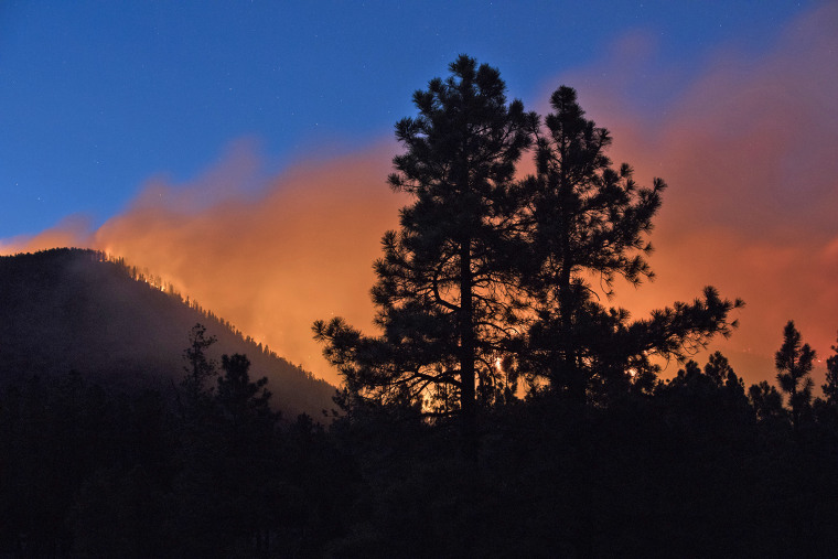 A wildfire burns through the Coconino National Forest, north of Flagstaff, Arizona, on July 21, 2019.