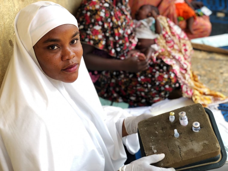 Aisha Shuaibu Mohammed holds the oral and injectable polio vaccines