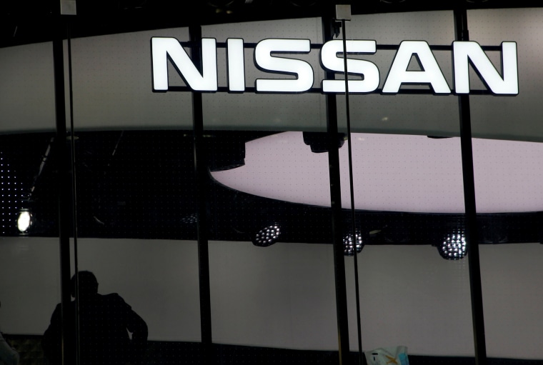 Image: FILE PHOTO: Man is silhouetted at a show room of Nissan Motor Co. in Tokyo